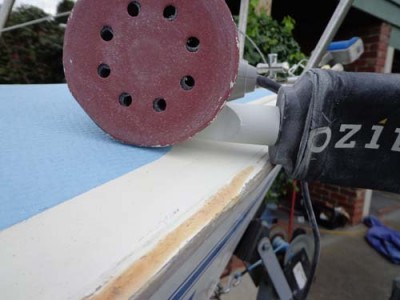 With the gunwales removed, the next task was to sand off any remnant rough wood and torn gel-coat, ready for resealing with white flow-coat.