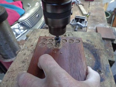 Cutting lines of plugs into a scrap piece of 25mm thick timber on the pedestal drill.