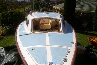 QUMBU with stanchions and hatches removed, but gunwales still painted.