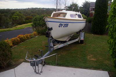 QUMBU with plum paint scrapped off gunwales to reveal original wood.