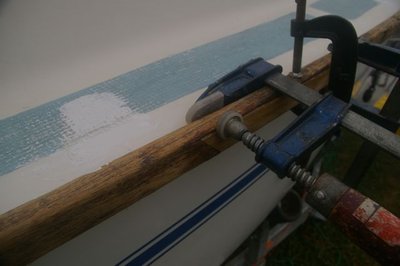 Wooden rubbing rail, showing insert of new hardwood piece to repair large section of rot.