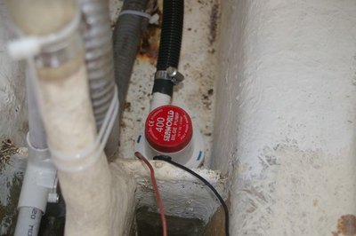 Close-up of new pump, screwed to bilge cross member
