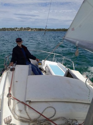 My elder brother at the helm. Not as good looking, but more experienced as a sailor. Outboard motor didn't get in the way or splash up any water from the well.