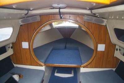 Inside cabin: note speakers, faux woodgrain panel ply lining board, marine carpets, cup-holders on walls, and new LED light on the underside of Pop-top (with curly cord extension for when it's raised).