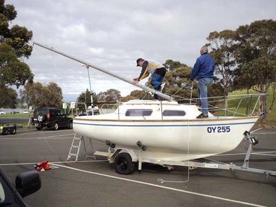 Raising the mast in the carpark at St Helen's. Note the mast raising arm attached to the inner transom; I have also bought a Mastmate and will let you know how that goes for single-handed raising.