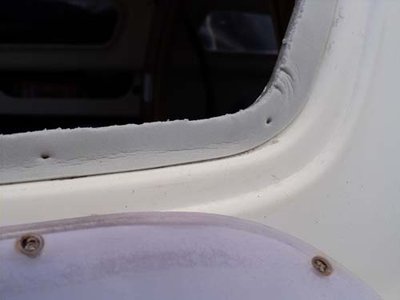 Close-up of white rubber adhered around edge of window frame