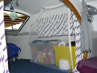 In the forward cabin, we've removed the cushions as there are only two of us and we sleep in the cabin bunks. This allows us to use the forward cabin for storage. &quot;Cargo&quot; net is made out of bird netting.